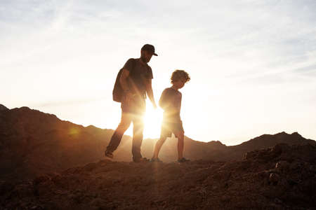 Dad with son in the mountains in the desertの写真素材