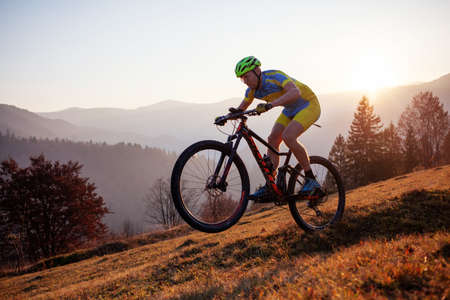 Cyclist in the autumn mountainの写真素材