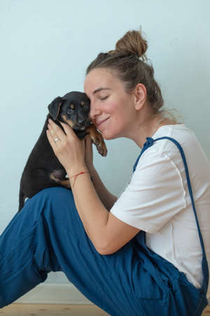 Woman with little dog at homeの写真素材