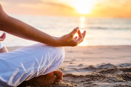 Beautiful woman doing yoga by the seaの写真素材
