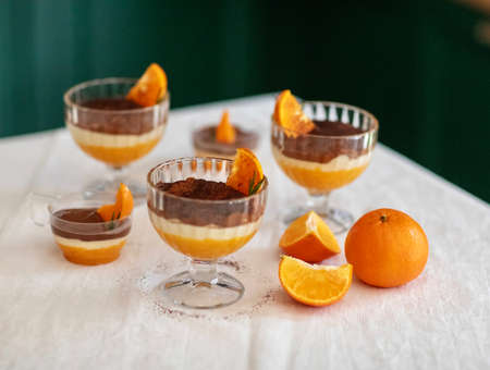 Homemade tiramisu with tangerines on a tableの写真素材