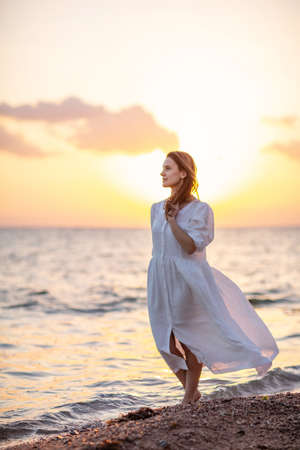 Beautiful woman relaxes by the seaの写真素材