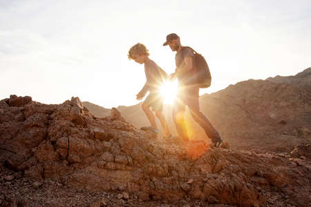 Dad with son in the mountains in the desertの写真素材
