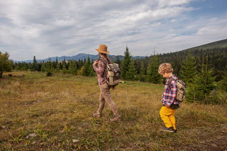 Happy family resting in the mountains in autumnの写真素材