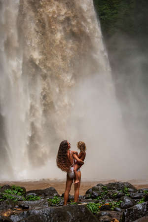 Mom and son near a waterfall in Baliの写真素材