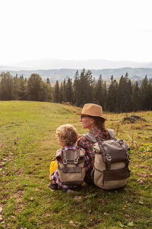 Happy family resting in the mountains in autumnの写真素材