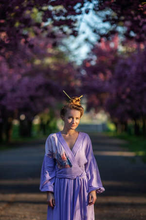 Beautiful woman in a sakura gardenの写真素材