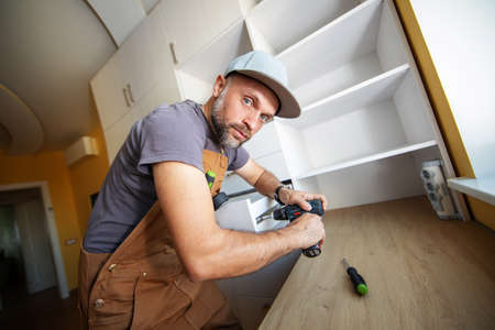 Carpenter makes furniture in the roomの写真素材
