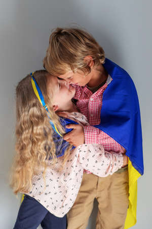 Children of Ukraine: a boy and a girl with the flag of Ukraineの写真素材