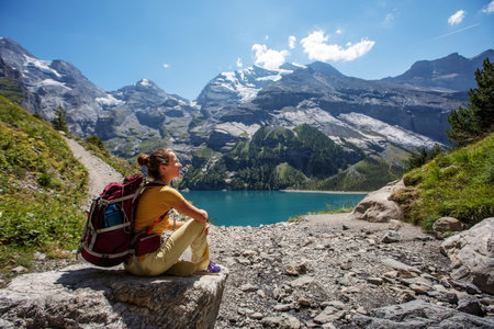 Tourist in the mountains in Switzerland on Lake Oeschinenseeの写真素材