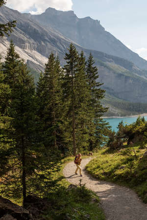 Tourist in the mountains in Switzerland on Lake Oeschinenseeの写真素材