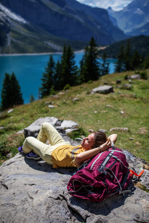 Tourist in the mountains in Switzerland on Lake Oeschinenseeの写真素材