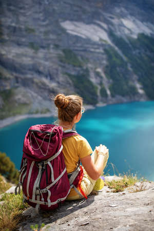 Tourist in the mountains in Switzerland on Lake Oeschinenseeの写真素材