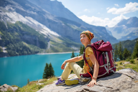 Tourist in the mountains in Switzerland on Lake Oeschinensee