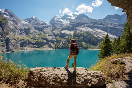 Tourist in the mountains in Switzerland on Lake Oeschinenseeの写真素材