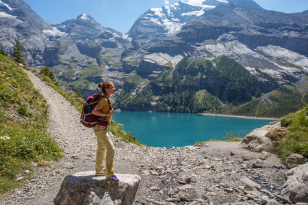 Tourist in the mountains in Switzerland on Lake Oeschinenseeの写真素材