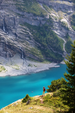 Tourist in the mountains in Switzerland on Lake Oeschinenseeの写真素材
