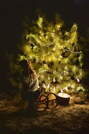 Happy family in the forest near the Christmas treeの写真素材