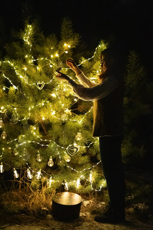 Happy family in the forest near the Christmas treeの写真素材