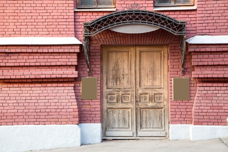 large old wood door in brick wall, horizontalの写真素材