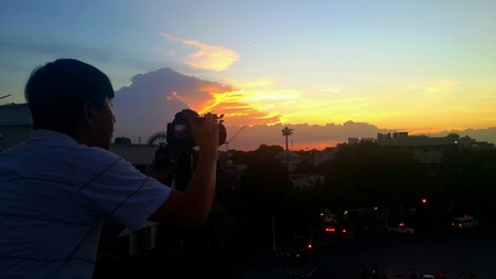Photographer take a photo of sunset