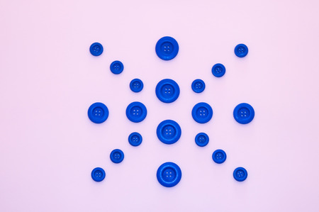 figure formed with blue buttons and white backgroundの写真素材