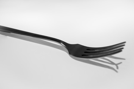 shadow of a fork bent at the edgesの写真素材