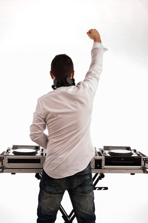 Man deejay back against the white background and raised fistの写真素材