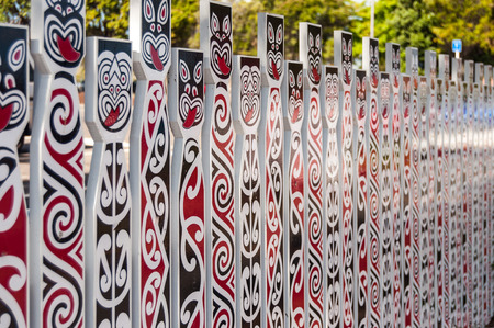close up of fence with traditional Maori facesの写真素材