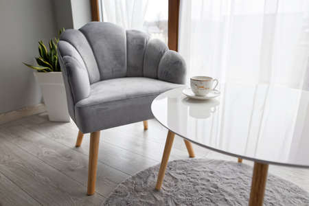 Modern Interior With Gray Armchair And White Coffee Table