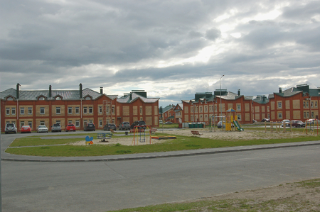 June 9, 2013. The city of Khanty-Mansiysk. Modern cottage on the background of multi-storey buildings in the backgroundのeditorial素材