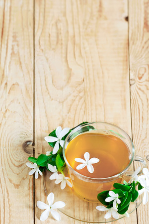 Green tea with jasmine blossom. Copy space background.の写真素材