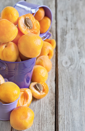Sweet ripe apricots in small violet buckets.の写真素材