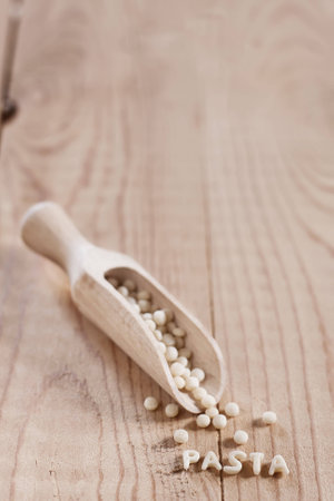 Ptititm or israeli couscous - kind of small pasta, traditional for israelian cuisine. Copy space background.の写真素材