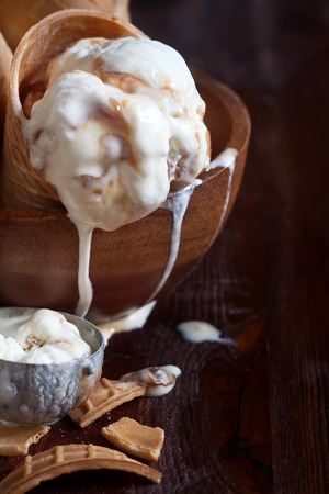 Homemade ice cream with salted caramel in waffle cones. Copy space background.の写真素材