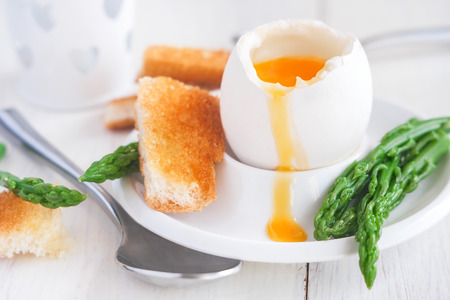 Soft boiled eggs with asparagus and toast soldiersの写真素材