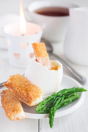 Soft boiled eggs with asparagus and toast soldiersの写真素材
