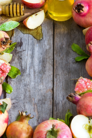 Apples, pomegranate and honey - symbols of judaic holiday Rosh Hashana (Jewish New Year). Selective focus. Copyspace background.の写真素材