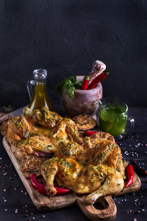 Flattaned out roasted golden chicken - chicken tabaka, traditional meal of georgian cuisine. Copyspace background.の写真素材