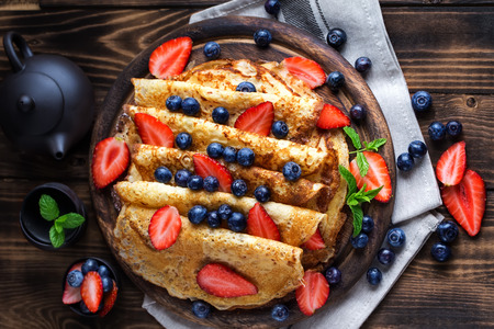 Healthy vegan pancakes crepe with blueberry and strawberry.の写真素材
