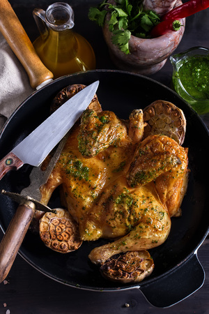 Flattaned out roasted golden chicken - chicken tabaka, traditional meal of georgian cuisine.の写真素材