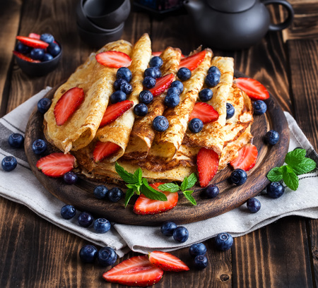 Healthy vegan pancakes crepe with blueberry and strawberry.の写真素材