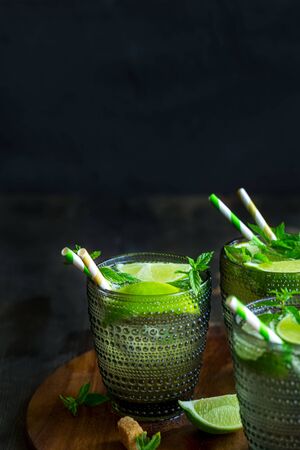 Chilled homemade mojito coctail with lime, mint and brown palm sugar. Copyspace background.の写真素材