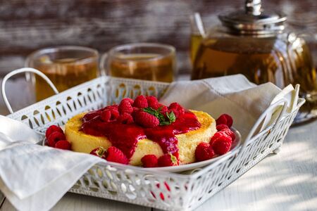 Japan cotton cheescake with raspberry sauce and green teaの写真素材