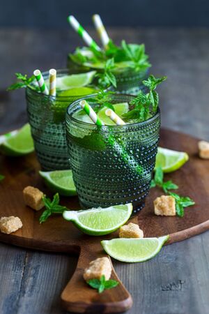 Chilled homemade mojito coctail with lime, mint and brown palm sugarの写真素材