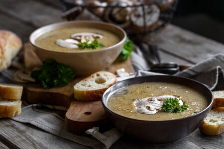Delicious homemade mushrooum soup puree with portobello and wild mushrooms on rustic tableの写真素材