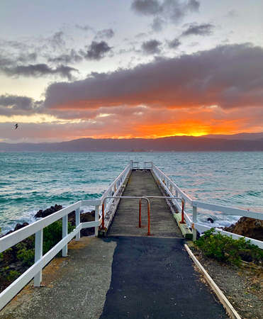 Sunrise over Karaka Bay Wharf, Wellington, New Zealandの写真素材