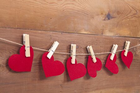 Red heart sign on wooden background. Heart, love and valentines day concept.の写真素材