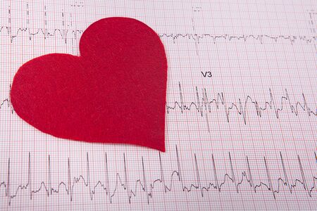 Tiny red heart sign on heart chart background. Health concept.