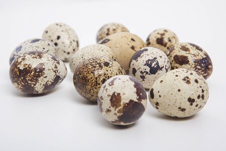 Quail eggs on white background.